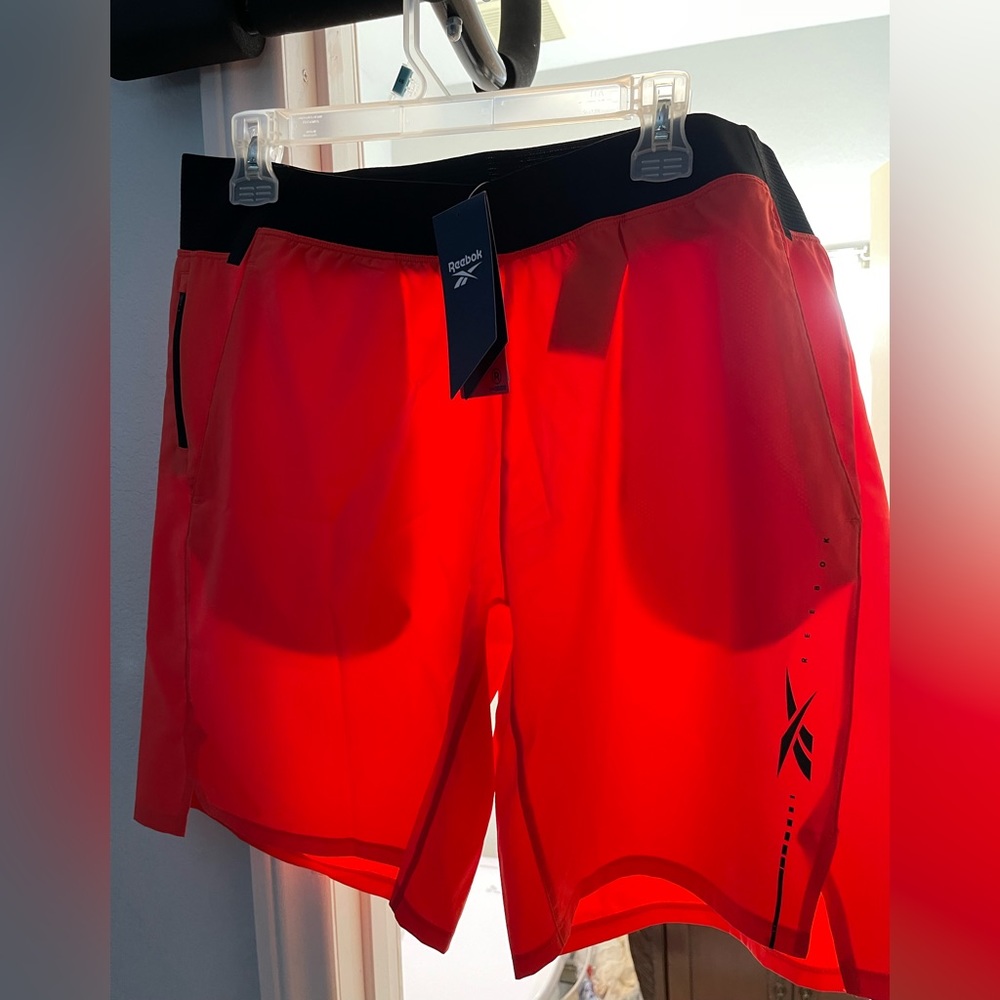 Reebok orange training shorts. Never worn w/tags. L.